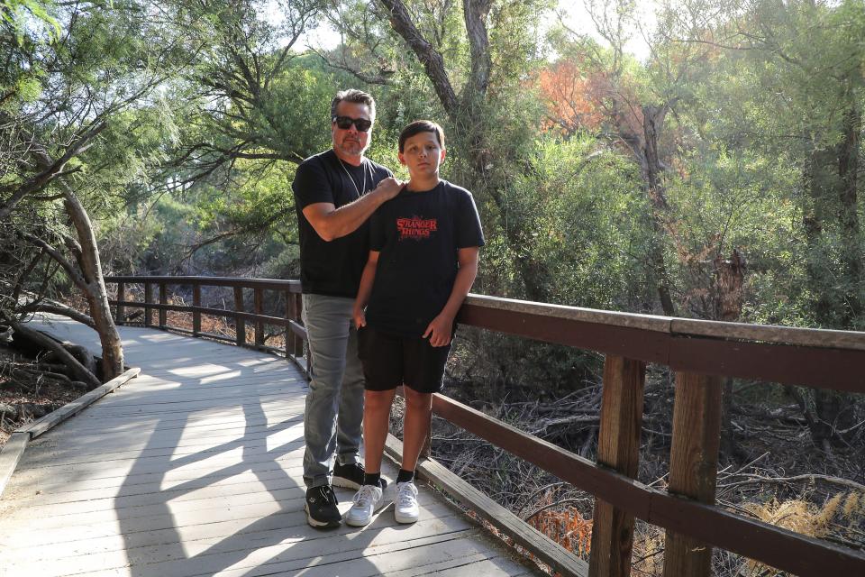 Musician John Garcia and his son Marshall are photographed at the Big Morongo Canyon Preserve, August 22, 2022.  John will be playing a benefit concert for Amy's Purpose, a nonprofit assisting people who have lost animals due to coyote and other predator attacks.