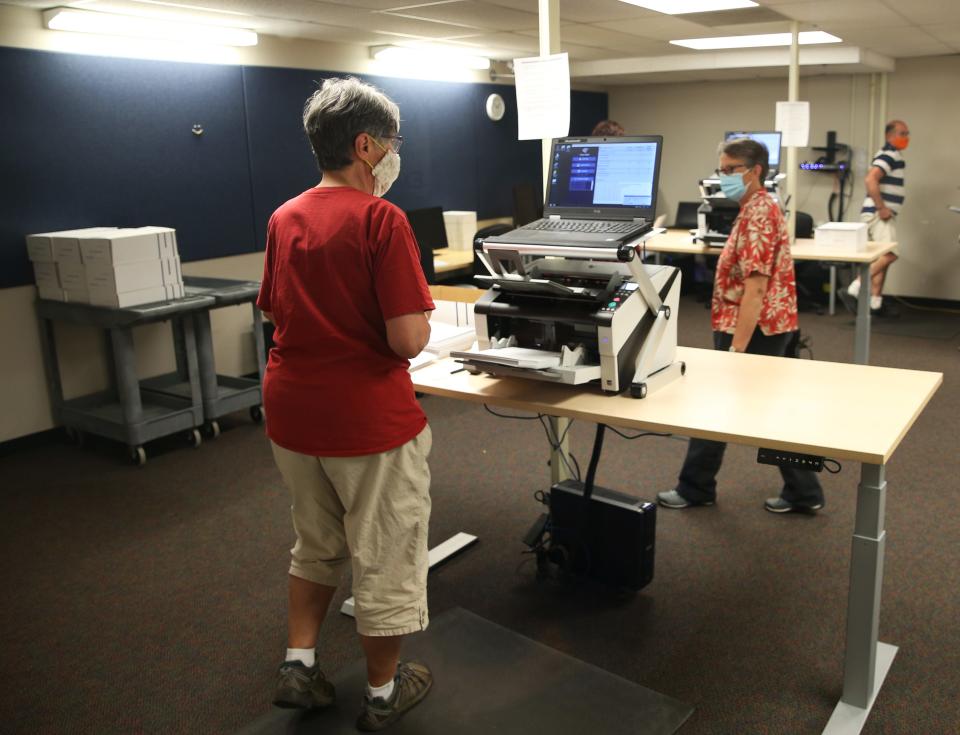 Election workers count ballots inside of a secure room in the Lane County Election building in Eugene.