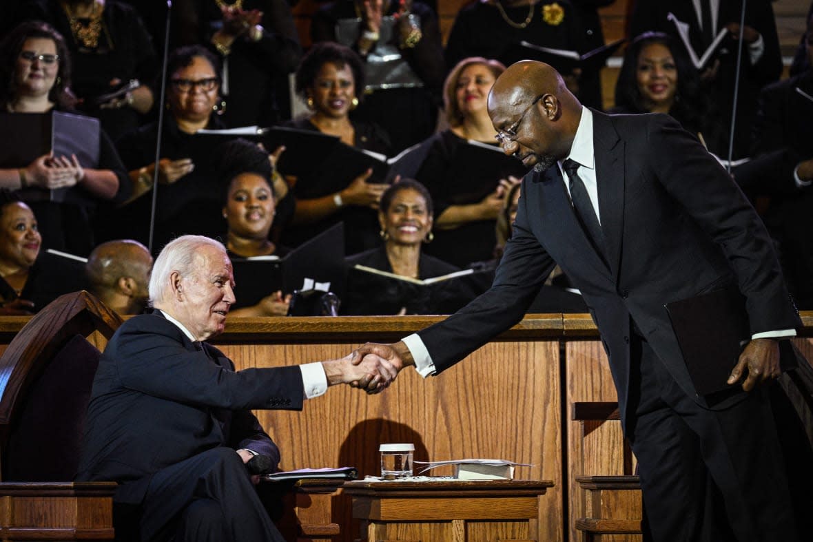 US Senator Raphael Warnock (D-GA), the pastor at Ebenezer Baptist Church, greets US President Joe Biden during a worship service in Atlanta, Georgia, on January 15, 2023, the eve of the national holiday honoring civil rights leader Martin Luther King, Jr. – King was co-pastor of the church from 1960 until his assassination in 1968. (Photo by Brendan SMIALOWSKI / AFP) (Photo by BRENDAN SMIALOWSKI/AFP via Getty Images)