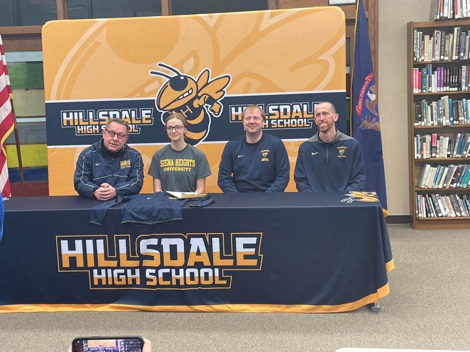 Rianna Vincent signs with Siena Heights University to continue her track and field career. She was joined by future head coach Kirk Richards (left) and her current coaches Clay Schiman and Rob Salisbury.