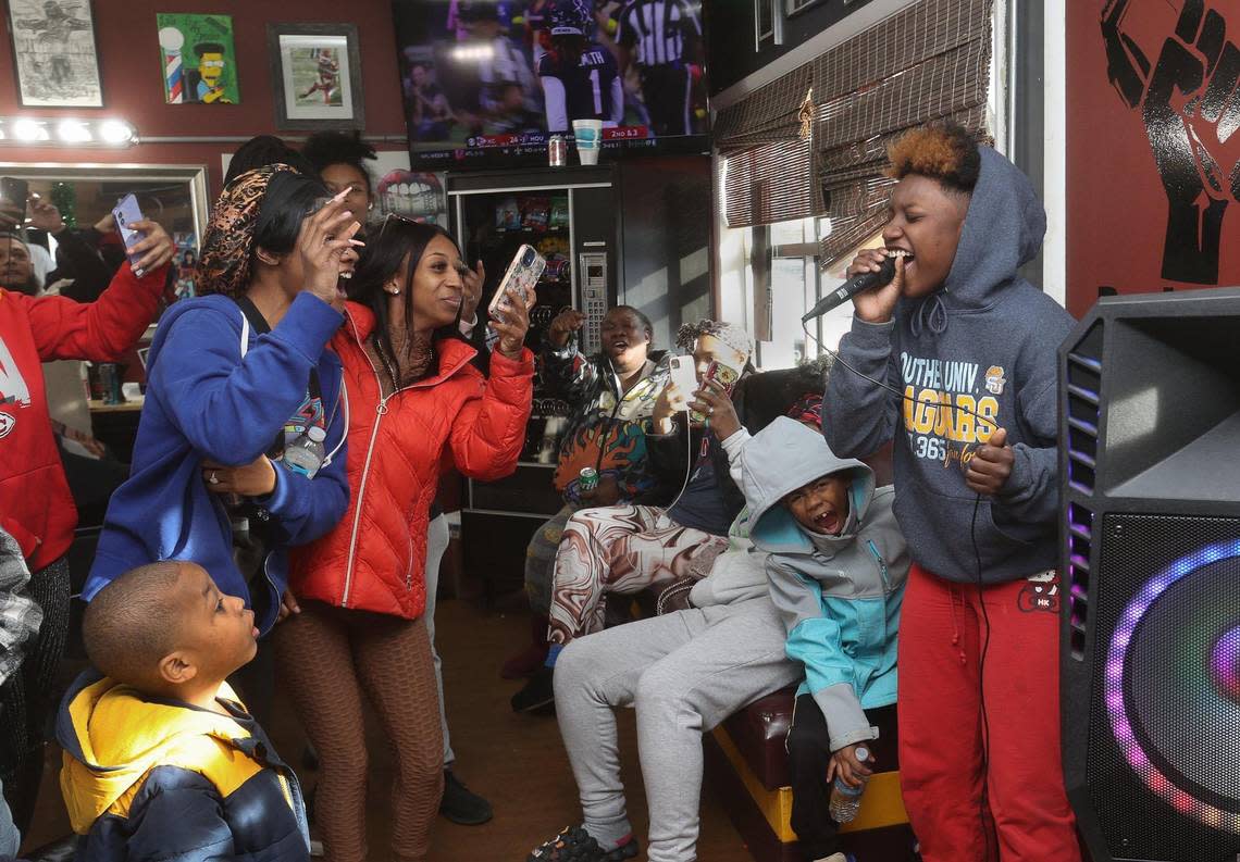 Dalyria Jones, 16, rocked out with encouragement from the crowd during a holiday sing-along following a dance contest at Draque’s.