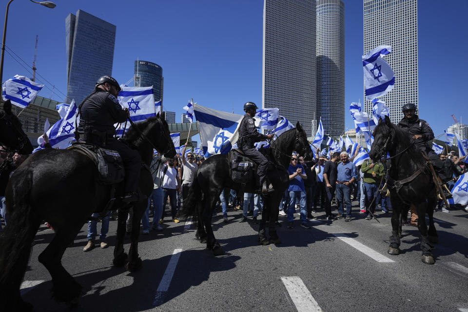 Mounted police are deployed as Israelis block a main road to protest against plans by Prime Minister Benjamin Netanyahu's new government to overhaul the judicial system, in Tel Aviv, Israel, Thursday, March 9, 2023. (AP Photo/Ohad Zwigenberg)