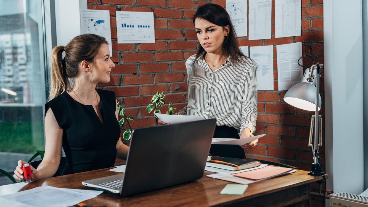 administrative assistant talking to boss