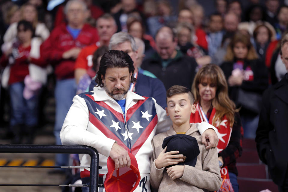 A man dressed as Evel Knievel prays with a boy prays during the invocation at the start of a campaign rally for President Donald Trump in Bossier City, La., Thursday, Nov. 14, 2019. (AP Photo/Gerald Herbert)