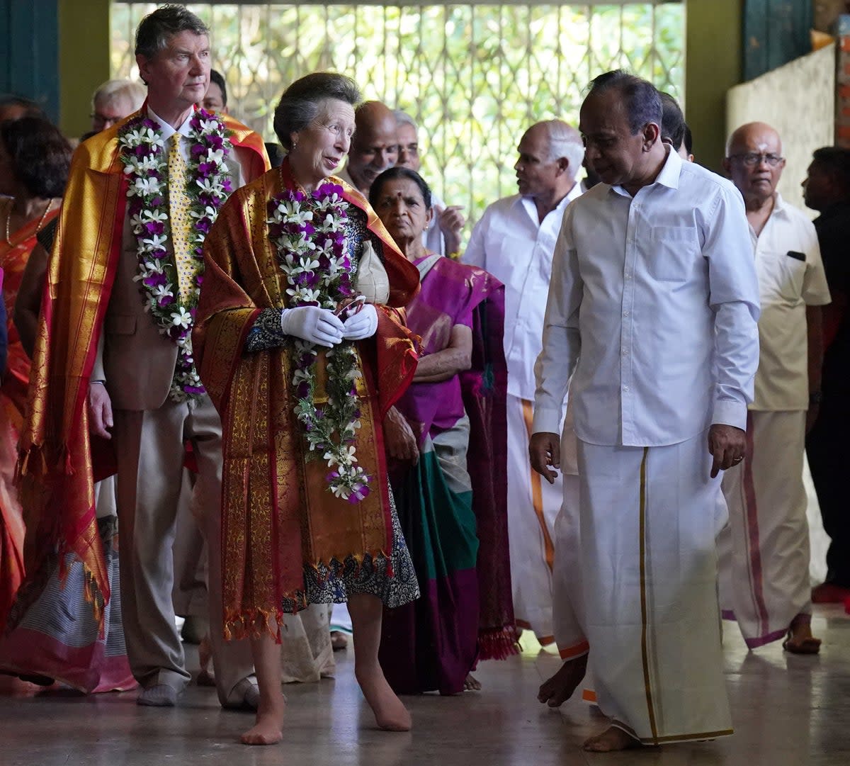 The Princess Royal and her husband Vice Admiral Sir Timothy Laurence during a visit to Vajira Pillayar Kovil Hindu temple in Colombo, Sri Lanka (PA)