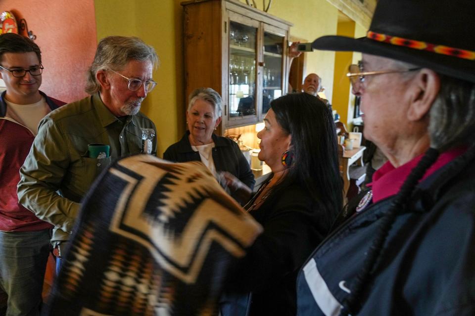 Racheal Starr, secretary-treasurer of the Tonkawa, presents Dave Cunningham with a blanket bearing the seal of the Tonkawa during a private luncheon. Cunningham, a real estate agent, has spent 30 years trying to preserve Sugarloaf Mountain.