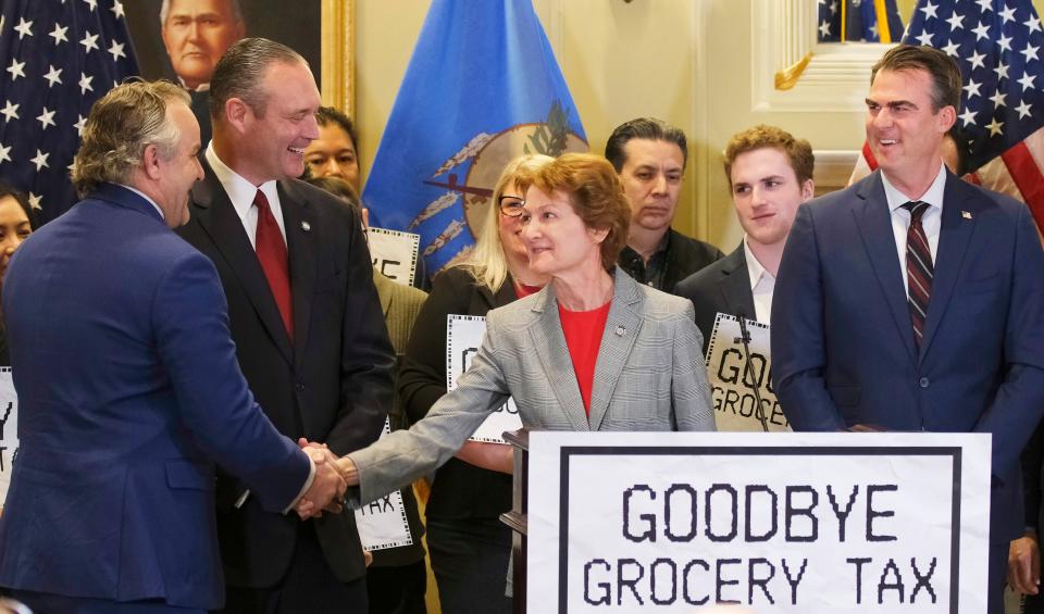 Senate Minority Leader Kay Floyd shakes hands with Senate Pro Tem Greg Treat on Tuesday at the signing ceremony for the grocery tax cut bill.