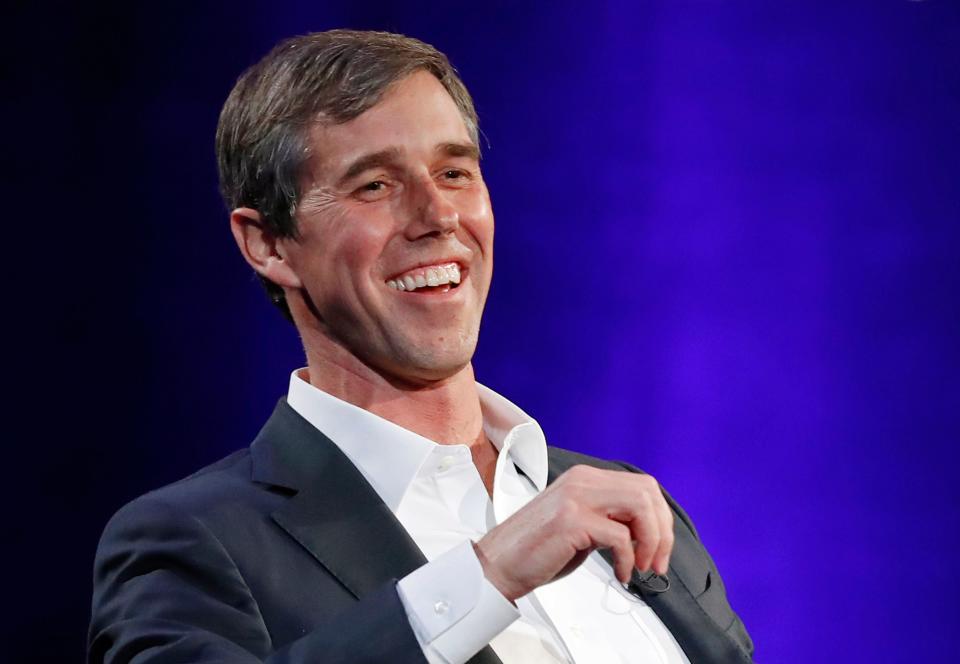 Former Democratic Texas congressman Beto O'Rourke laughs during a live interview with Oprah Winfrey on a Times Square stage at "SuperSoul Conversations," in New York, Feb.5, 2019.