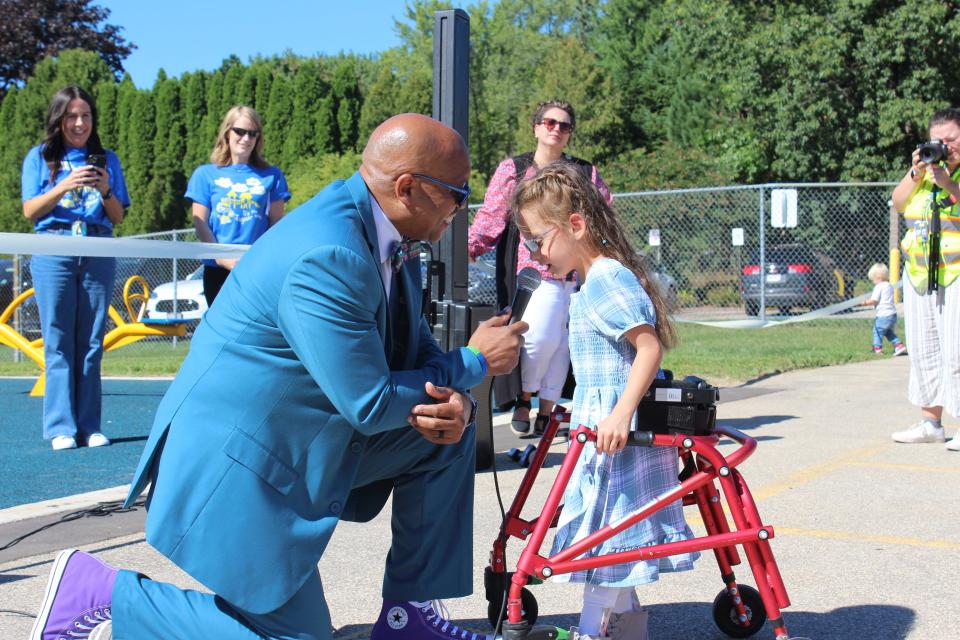 Green Bay School District Superintendent Claude Tiller talks with a student Aug. 30 at the ribbon-cutting for Jackson Elementary School's new playground in Green Bay.