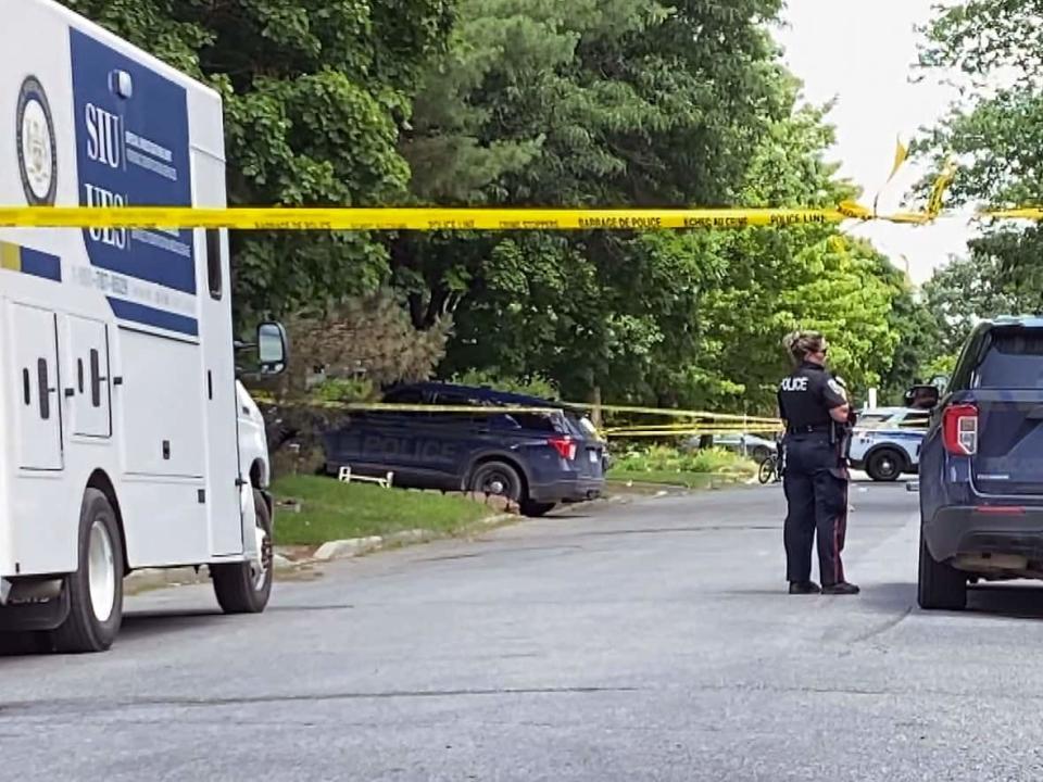 Police tape seen here at the crime scene on Tuesday had been taken down by Wednesday afternoon, when special cleaners were waiting to enter the Ready family home. (Stu Mills/CBC - image credit)