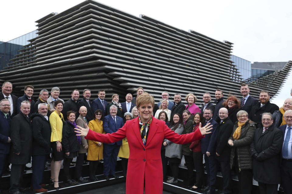 Scottish First Minister Nicola Sturgeon poses with newly elected MPs of Scottish National Party (SNP) during a photo opportunity as they gather outside the V&A Museum in Dundee, Scotland, Saturday Dec. 14, 2019. Sturgeon delivered a landslide election victory for the SNP, with a campaign focused on demands for a second referendum on Scottish independence, but Prime MinisterBoris Johnson has flatly rebuffed the idea of another vote. (Andrew Milligan/PA via AP)