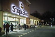 FILE - In this Friday, March 20, 2020 file photo, customers wait in line at a Stop & Shop supermarket that opened special morning hours to serve people 60-years and older due to coronavirus concerns, in Teaneck, N.J. The outbreak of the coronavirus has dealt a shock to the global economy with unprecedented speed as it continues to spread across the world. Stop & Shop will hire at least 5,000 new associates for regular part-time positions in its stores, distribution centers and delivery operations across New York, New Jersey, Connecticut, Massachusetts and Rhode Island. (AP Photo/John Minchillo, File)