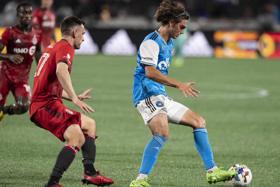 Toronto FC defender Shane O'Neill, left, defends against Charlotte FC midfielder Benjamin Bender, right, during the second half of an MLS soccer match, Saturday, Aug. 27, 2022, in Charlotte, N.C. (AP Photo/Matt Kelley)