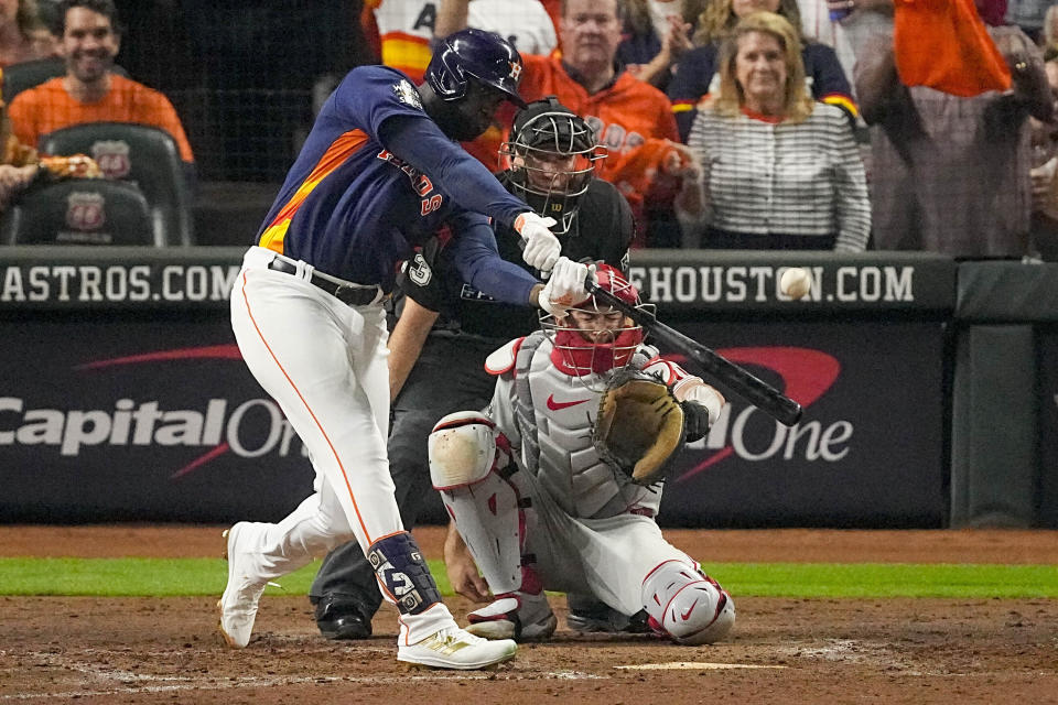 FILE - Houston Astros' Yordan Alvarez hits a three-run home run during the sixth inning in Game 6 of baseball's World Series against the Philadelphia Phillies on Saturday, Nov. 5, 2022, in Houston. Astros All-Star Yordan Alvarez has a sore hand that will keep him out of batting practice in the first few days of spring training. Alvarez told reporters on Tuesday soreness in the hand was an issue at times in the 2022 season and continued to “flare up a bit at times” during the offseason. (AP Photo/Sue Ogrocki, File)