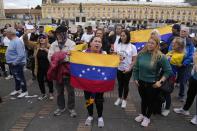 Supporters of opposition leader María Corina Machado sing their national anthem during a protest demanding free and fair elections in Venezuela's upcoming election, in Bolivar Square in Bogota, Colombia, Saturday, April 6, 2024. (AP Photo/Fernando Vergara)