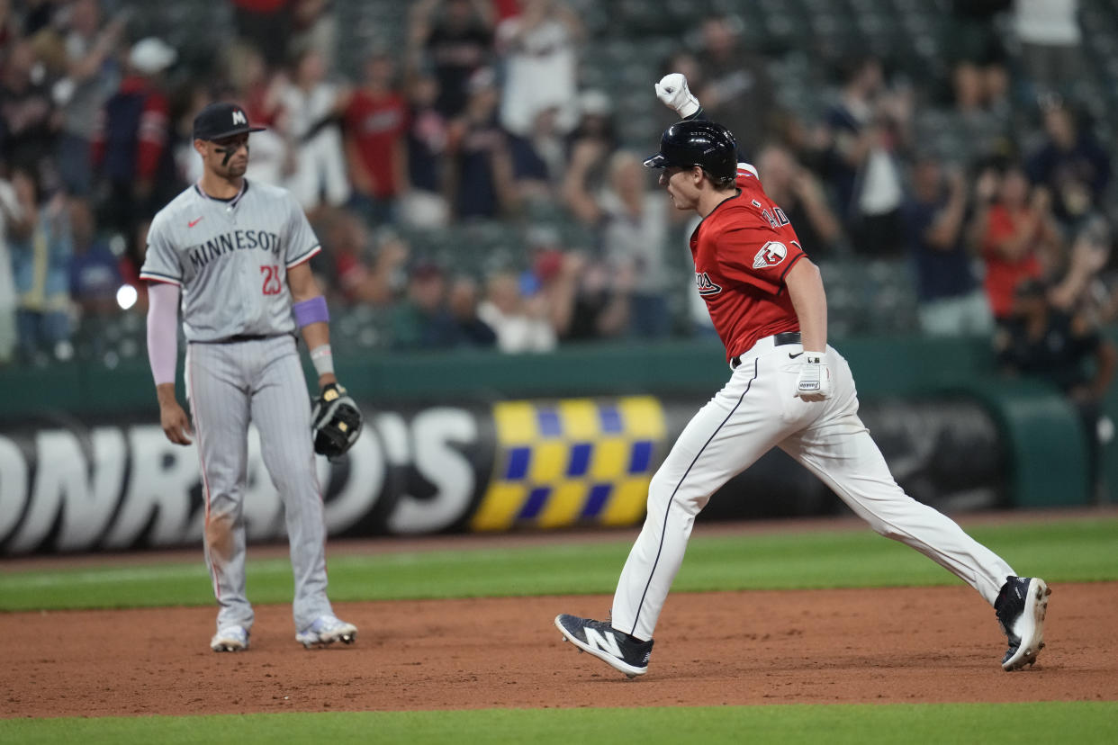 Cleveland Guardians' Kyle Manzardo, right, celebrates as he runs the bases with a home run in the eighth inning of a baseball game against the Minnesota Twins, Monday, Sept. 16, 2024, in Cleveland. Twins' third baseman Royce Lewis is at left. (AP Photo/Sue Ogrocki)