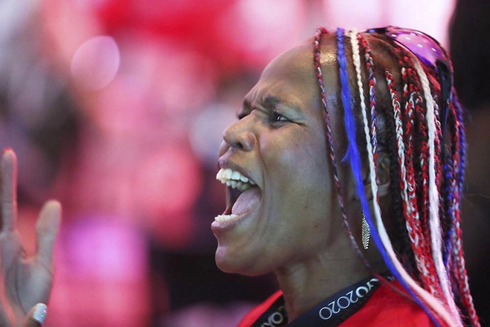 Venus Jewett, mother of Olympic runner Isaiah Jewett, watches her son compete in the 800-meter race as she joins other family and friends of Olympic athletes watching the televised action live at the Olympic Family & Friends Experience at the Loews Sapphire Falls Resort at Universal Orlando in Orlando, Fla., Friday, July 30, 2021. Parents, siblings, friends and former teammates crowd into the ballroom at the resort daily to watch the Summer Games and bond with others in a similar situation, all of them unable to be in Tokyo to root on their loved ones competing for gold because of the coronavirus pandemic. (Stephen M. Dowell/Orlando Sentinel via AP)