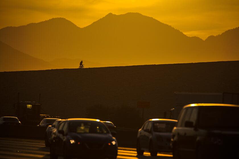Irwindale, CA - June 15: Sunrise over Los Angeles County marking a new post-COVID era for California. The state at 12:01 a.m. Tuesday rescinded most mask rules for vaccinated people and ended capacity limitations on businesses and venues. Traffic and other recreational activities are getting back to pre-COVID days on 605 Freeway and on Santa Fe Dam on Tuesday, June 15, 2021 in Irwindale, CA. (Irfan Khan / Los Angeles Times)