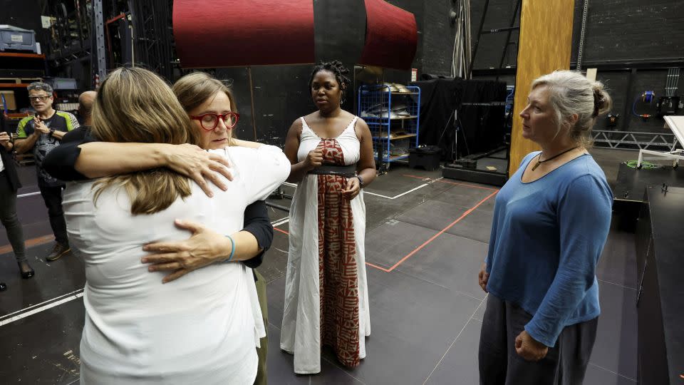 Performers are invited to "connect with a hug" at the start of rehearsals. - Albert Gea/Reuters