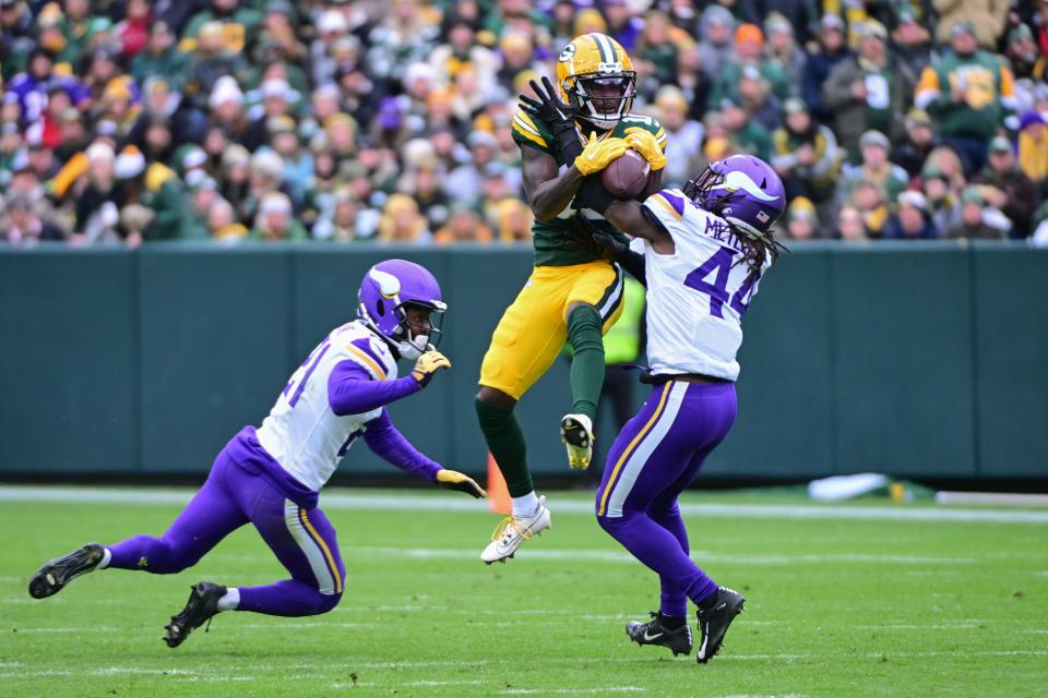 Oct 29, 2023; Green Bay, Wisconsin, USA; Minnesota Vikings safety Josh Metellus (44) intercepts a pass intended for Green Bay Packers wide receiver Jayden Reed (11) in the third quarter at Lambeau Field. Mandatory Credit: Benny Sieu-USA TODAY Sports