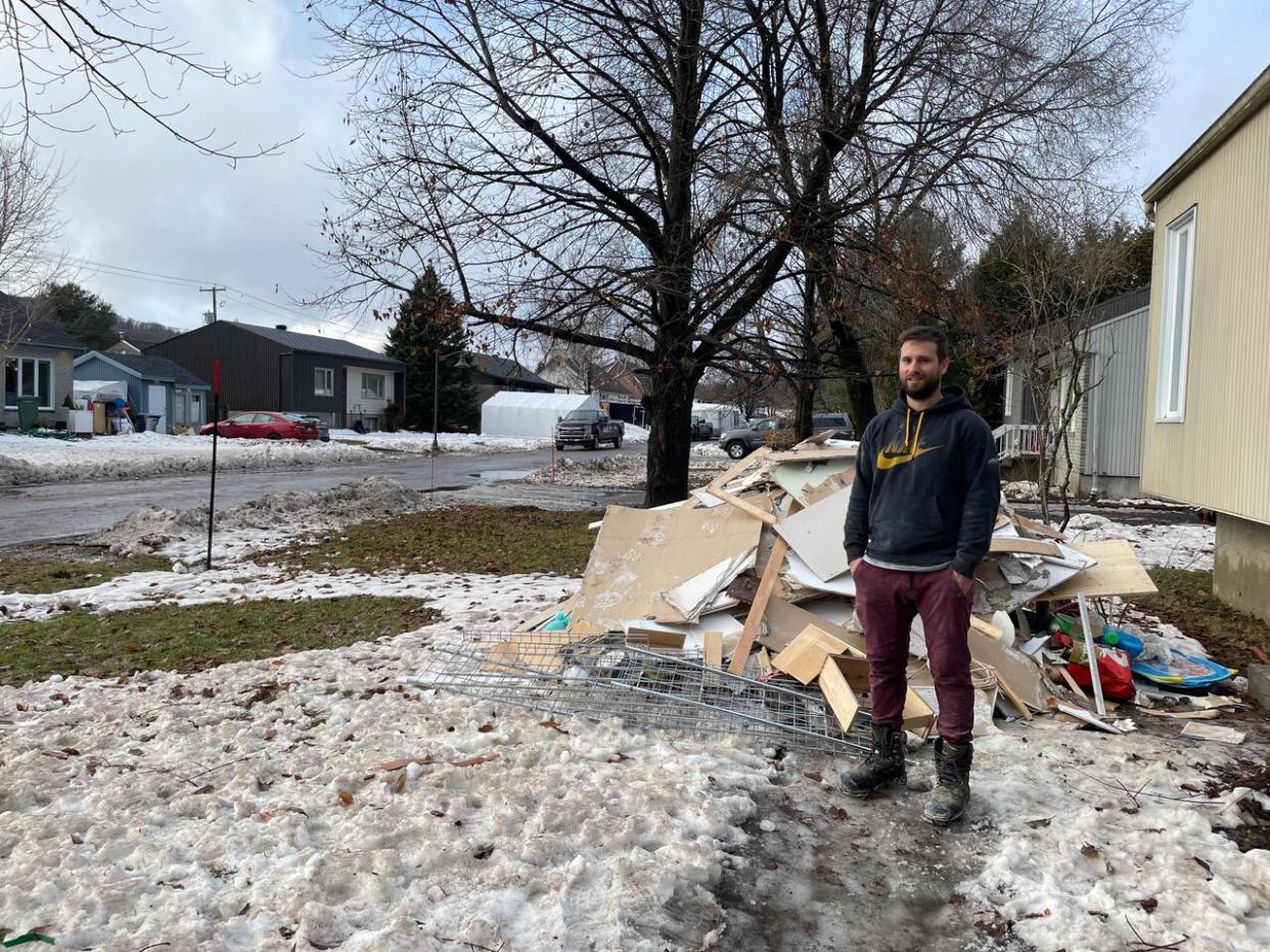 Frédéric Hurens is cleaning up his basement after Monday's rainfall flooded part of his basement in Lac-Beauport, Que.  (Émilie Warren/CBC - image credit)