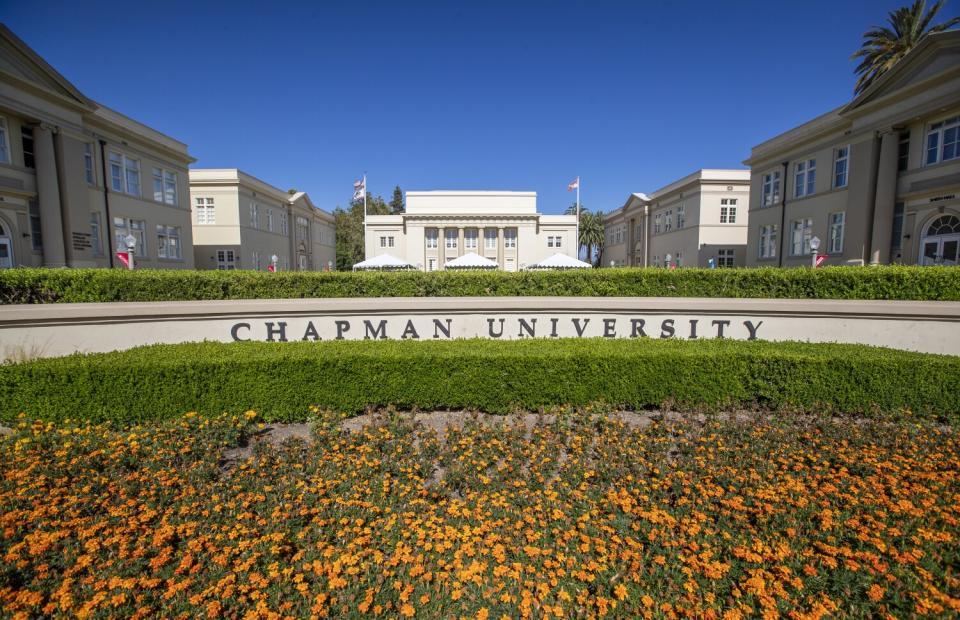 A view of Chapman University, with a garden of orange flowers.