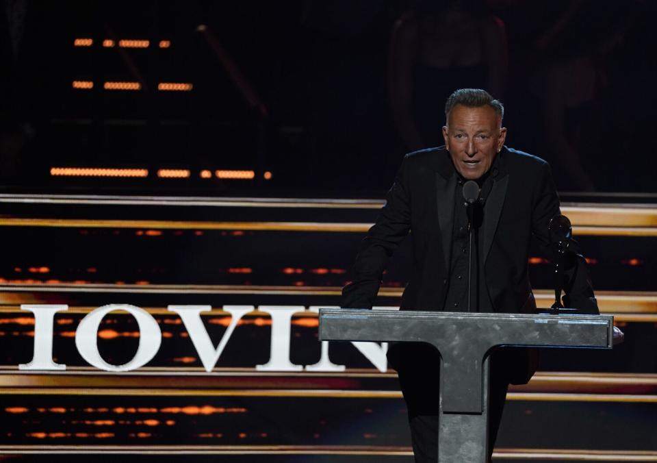 A man speaks from a podium onstage