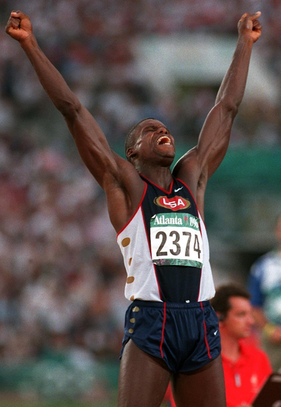 FILE - In this Monday, July 29, 1996, file photo, Carl Lewis of the United States celebrates after his third jump in the men's long jump final at the 1996 Summer Olympic Games in Atlanta. (AP Photo/Diether Endlicher, File)
