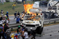 <p>Demonstrators clash with a riot police armored car during a rally against Venezuela’s President Nicolas Maduro in Caracas, Venezuela May 1, 2017. (Photo: Carlos Garcia Rawlins/Reuters) </p>