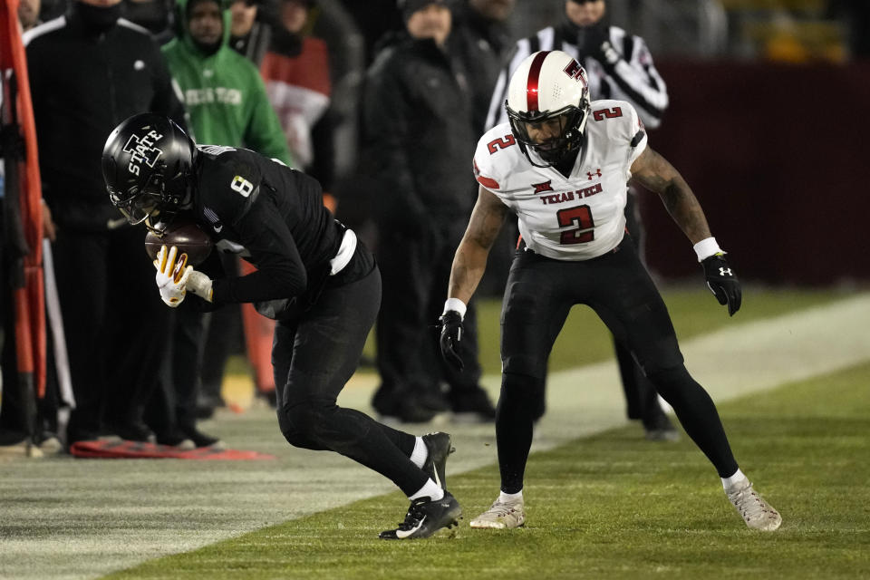 Iowa State wide receiver Xavier Hutchinson (8) catches a pass ahead of Texas Tech defensive back Reggie Pearson Jr. (2) during the first half of NCAA college football game, Saturday, Nov. 19, 2022, in Ames, Iowa. (AP Photo/Charlie Neibergall)