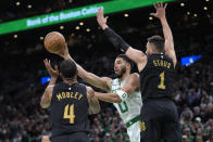 Boston Celtics forward Jayson Tatum (0) passes the ball as Cleveland Cavaliers forward Evan Mobley (4) and guard Max Strus (1) defend during the first half of Game 2 of an NBA basketball second-round playoff series Thursday, May 9, 2024, in Boston. (AP Photo/Steven Senne)