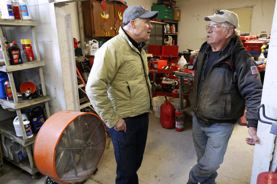 2020 Democratic presidential candidate Washington Gov. Jay Inslee talks with Ron Perry, of Hamburg, Iowa, right, while touring flood damage, Friday, April 12, 2019, in Hamburg, Iowa. (AP Photo/Charlie Neibergall)