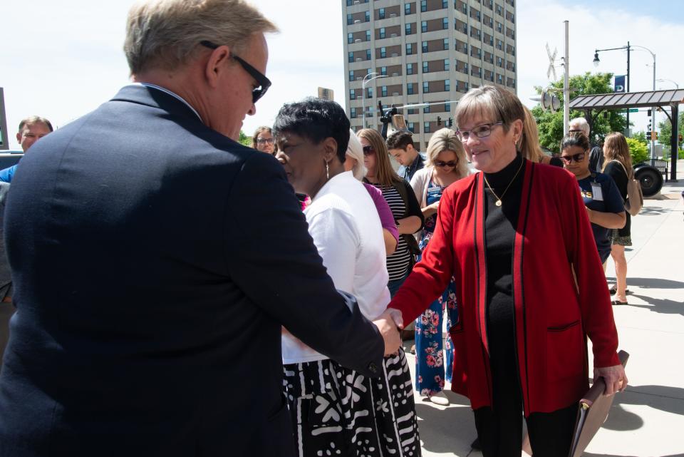 Curtis Sneden, president of the Topeka Chamber, shakes hand with Gov. Laura Kelly before a bill signing event Thursday in downtown Topeka.