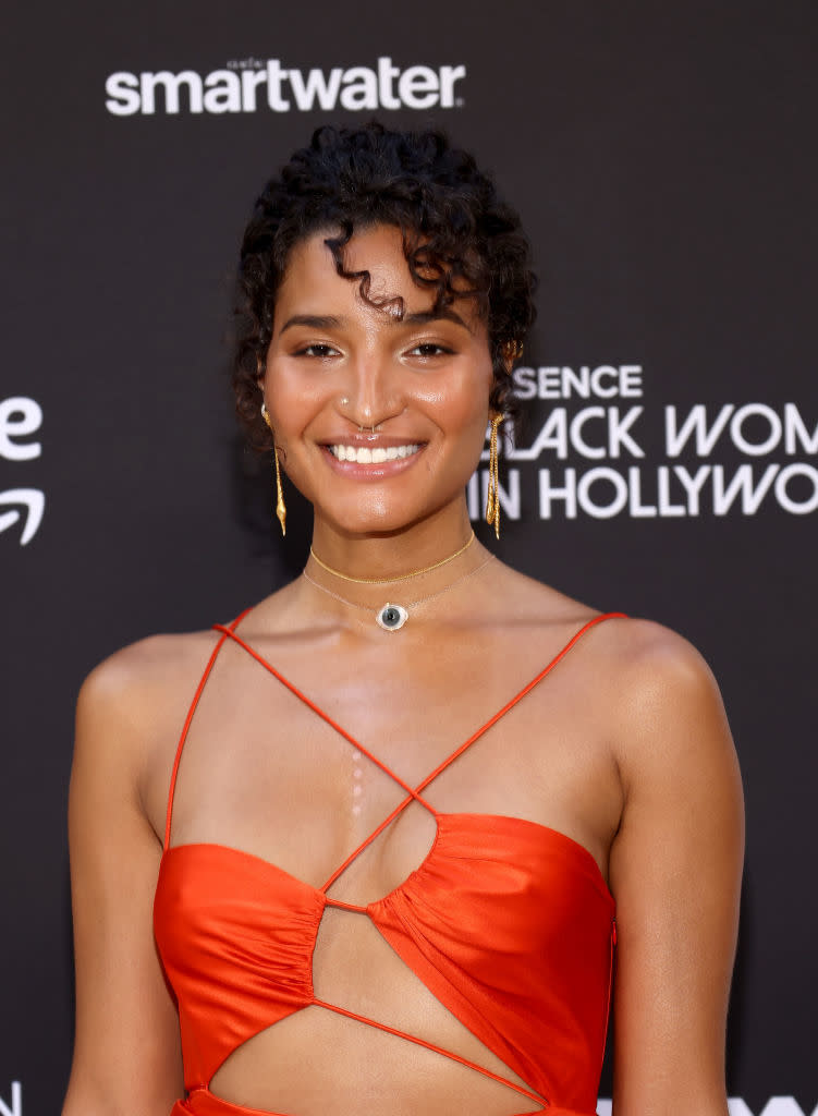 Indya in a cut-out dress smiles at the Essence Black Women in Hollywood event