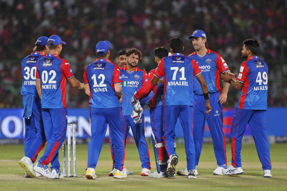 Delhi Capitals' Kuldeep Yadav, center, celebrates with teammates the wicket of Rajasthan Royals' Jos Buttler during the Indian Premier League cricket match between Delhi Capitals and Rajasthan Royals in Jaipur, India, Thursday, March 28, 2024. (AP Photo/Pankaj Nangia)