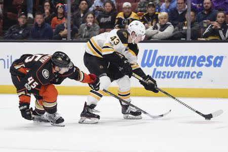 Nov 15, 2017; Anaheim, CA, USA; Boston Bruins center Danton Heinen (43) moves the puck under pressure by Anaheim Ducks defenseman Sami Vatanen (45) during the third period at Honda Center. Kelvin Kuo-USA TODAY Sports