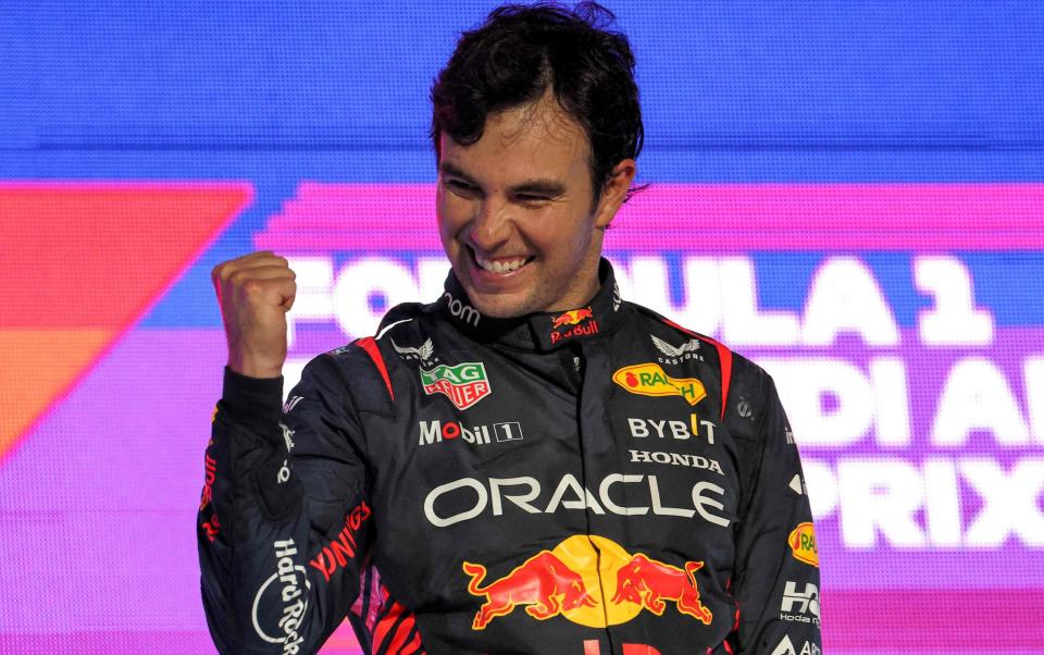 Red Bull Racing's Mexican driver Sergio Perez celebrates on the podium after winning the Saudi Arabia Formula One Grand Prix at the Jeddah Corniche Circuit in Jeddah on March 19, 2023. - Getty Images/Giuseppe Cacace