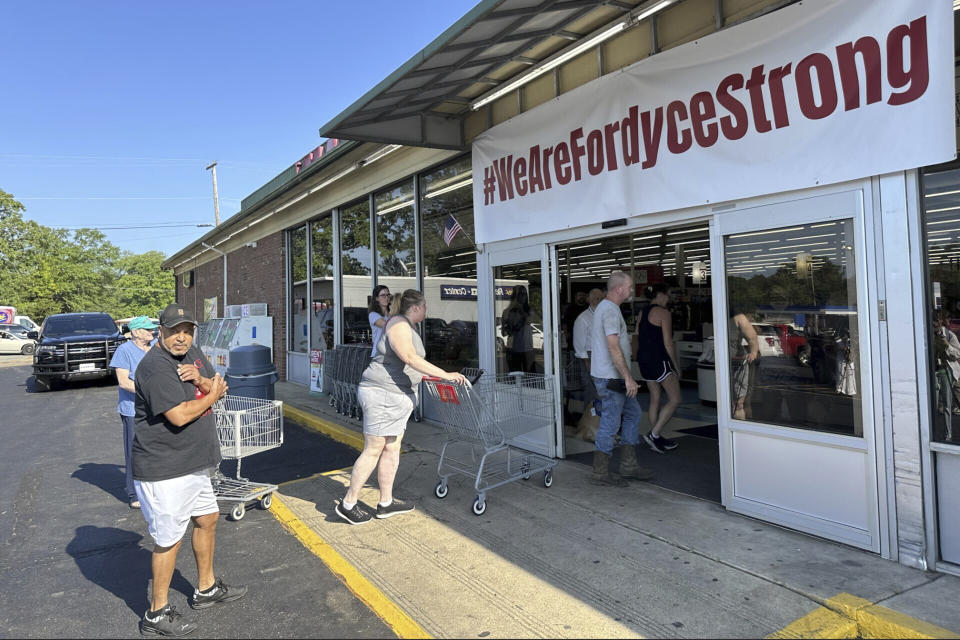 Shoppers enter the Mad Butcher grocery store in Fordyce, Arkansas on Tuesday, July 2, 2024. The grocery store reopened on Tuesday, 11 days after a mass shooting that killed four. (AP Photo/Andrew DeMillo)