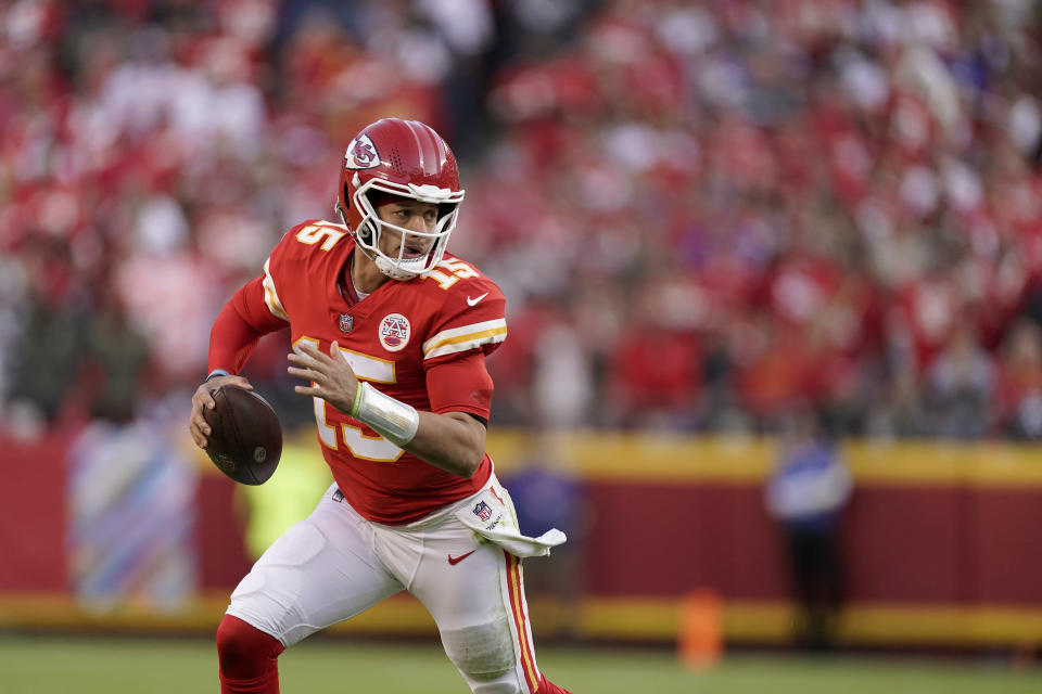 Kansas City Chiefs quarterback Patrick Mahomes scrambles during the second half of an NFL football game Sunday, Oct. 16, 2022, in Kansas City, Mo. (AP Photo/Charlie Riedel)