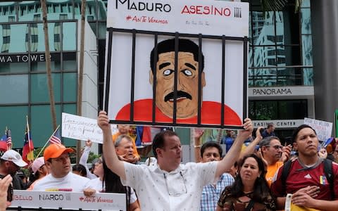 Venezuelan exiles take part in a protest against Nicolas Maduro in Miami, Florida - Credit:  GASTON DE CARDENAS/AFP