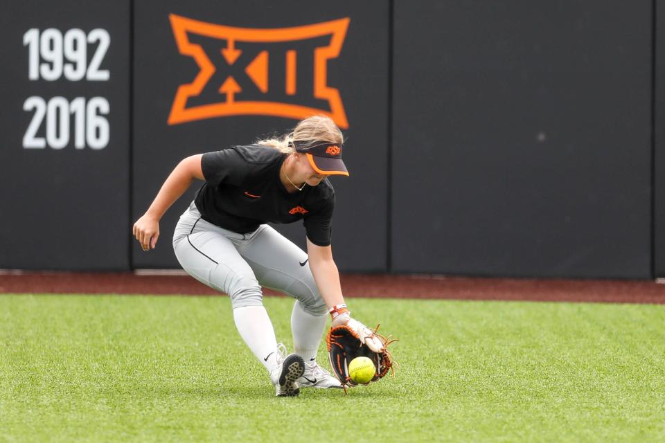 Oklahoma State outfielder Angelina Craig (17) fields a ball during a practice at Cowgirl Stadium in Stillwater, Okla., on Wednesday, May 24, 2023.