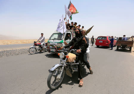 Taliban ride on a motorbike as they celebrate ceasefire in Rodat district of Nangarhar province, Afghanistan June 16, 2018.REUTERS/Parwiz