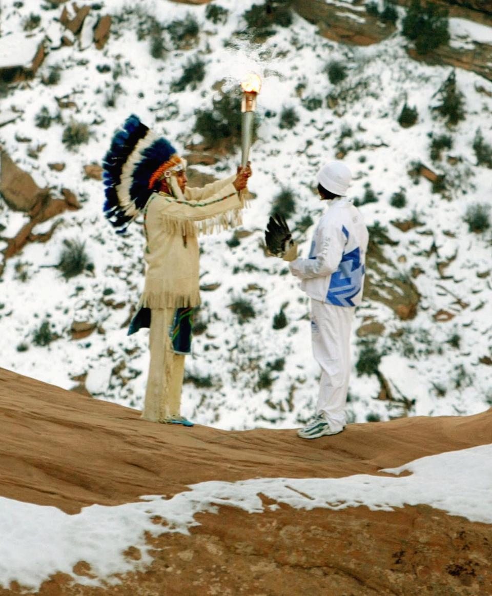 At left, Frank Arrowchis, a member of the Northern Ute Tribe, performed a ritual with his granddaughter Stephanie Laree Spann at the Delicate Arch in Arches National Park near Moab, Utah, in February 2002.