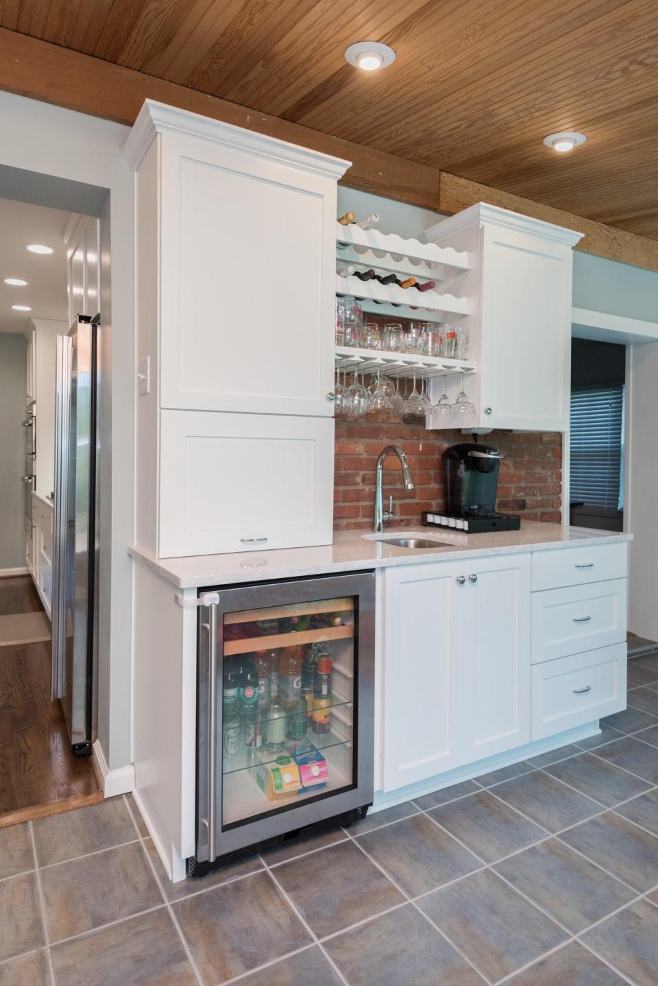 This kitchen renovations in Maryhill Estates features a small bar complete with seperate beverage fridge and coffee station.