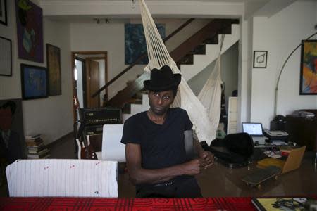 Nigerian musician Keziah Jones sits in his living room during an interview with Reuters at his home in Lagos February 25, 2014. REUTERS/Akintunde Akinleye