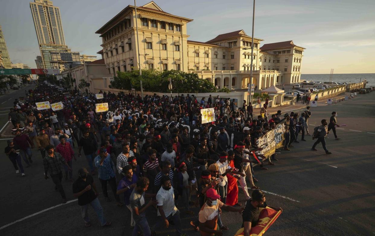 <span class="caption">Sri Lankan students march during a protest over the economic crisis outside the residence of prime minister <span class="caas-xray-inline-tooltip"><span class="caas-xray-inline caas-xray-entity caas-xray-pill rapid-nonanchor-lt" data-entity-id="Mahinda_Rajapaksa" data-ylk="cid:Mahinda_Rajapaksa;pos:1;elmt:wiki;sec:pill-inline-entity;elm:pill-inline-text;itc:1;cat:OfficeHolder;" tabindex="0" aria-haspopup="dialog"><a href="https://search.yahoo.com/search?p=Mahinda%20Rajapaksa" data-i13n="cid:Mahinda_Rajapaksa;pos:1;elmt:wiki;sec:pill-inline-entity;elm:pill-inline-text;itc:1;cat:OfficeHolder;" tabindex="-1" data-ylk="slk:Mahinda Rajapaksa;cid:Mahinda_Rajapaksa;pos:1;elmt:wiki;sec:pill-inline-entity;elm:pill-inline-text;itc:1;cat:OfficeHolder;" class="link ">Mahinda Rajapaksa</a></span></span> in Colombo, April 24, 2022. </span> <span class="attribution"><a class="link " href="https://newsroom.ap.org/detail/Sri%20Lanka%20Economic%20Crisis/3d3c6b6a0d0f4205a6b7a69ee194289e?Query=sri%20lanka&mediaType=photo&sortBy=arrivaldatetime:desc&dateRange=Anytime&totalCount=46937&currentItemNo=10" rel="nofollow noopener" target="_blank" data-ylk="slk:AP Photo/Eranga Jayawardena;elm:context_link;itc:0;sec:content-canvas">AP Photo/Eranga Jayawardena</a></span>