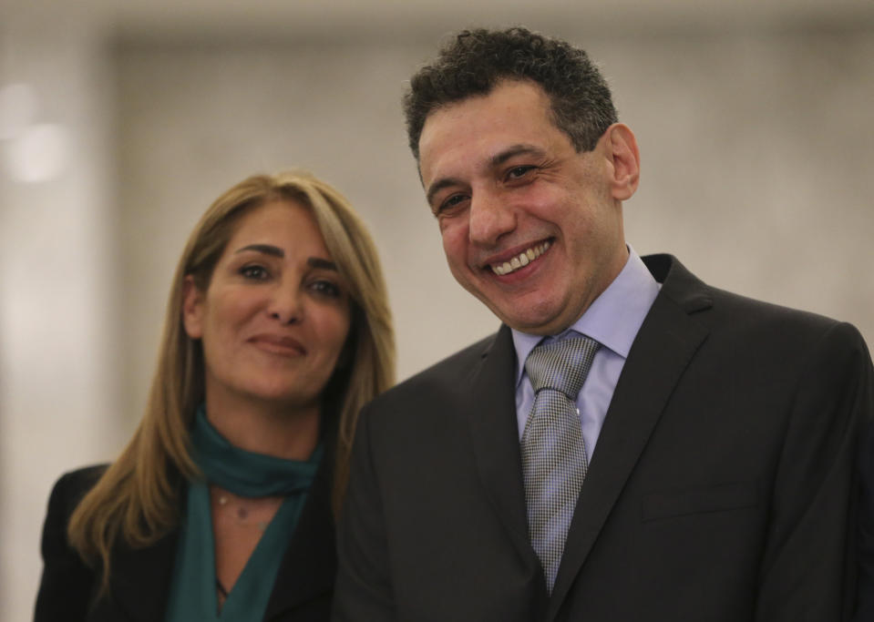 Nizar Zakka, right, a Lebanese citizen and U.S. permanent resident, who was released in Tehran after nearly four years in jail on charges of spying, smiles as he stands next to his wife Ghinwa, at the presidential palace, in Baabda, east of Beirut, Tuesday, June 11, 2019. Zakka a Lebanese businessman was allowed to fly to Lebanon, a development that comes amid heightened tensions between Iran and the U.S. after President Donald Trump withdrew America from Tehran's nuclear deal with world powers. (AP Photo/Hussein Malla)