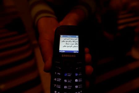 Olfa, 39, mother of Rahma, wife of Nurdine Chouchan, who was killed during a U.S. strike in Sebrata, Libya, shows a message on her mobile phone which was sent by her daughter during an interview with Reuters in Tunis, Tunisia, April 9, 2016. The message reads, "I am Rahma. I am in Sebrata, the situation is dangerous. I may die. I would like you to pray for me, the situation is dangerous." REUTERS/Zohra Bensemra