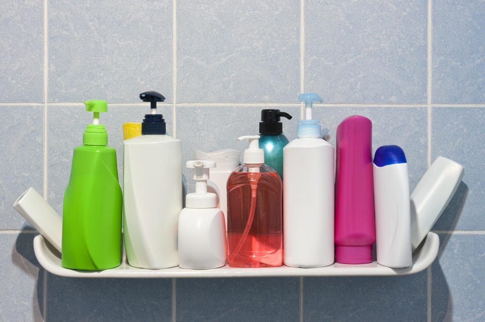 Many shampoo and soap bottles on a bathroom or shower shelf.(Photo: Getty)