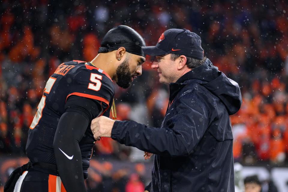 Oregon State coach Jonathan Smith congratulates quarterback DJ Uiagalelei on senior day before the game against the Washington Huskies in Corvallis, Oregon on Nov. 18, 2023.